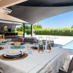 a pool with lounge chairs and towels