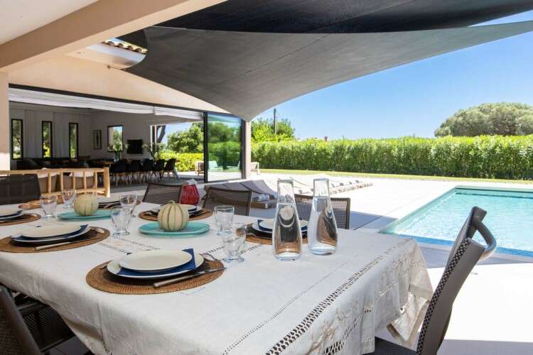 a pool with lounge chairs and towels